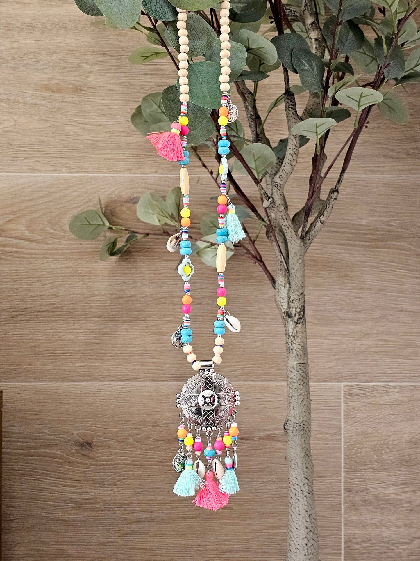 Aztec necklace with colorful beads, charms, and cowrie shell pendant