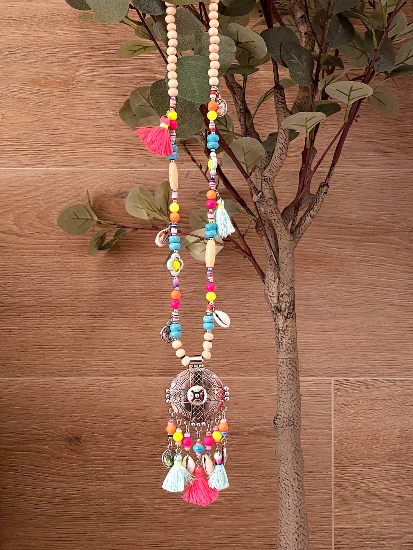 Aztec necklace with colorful beads, charms, and cowrie shell pendant