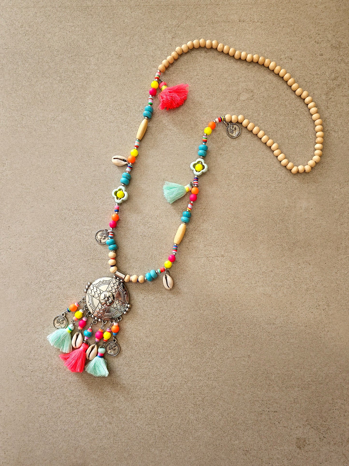 Aztec necklace with colorful beads, charms, and cowrie shell pendant