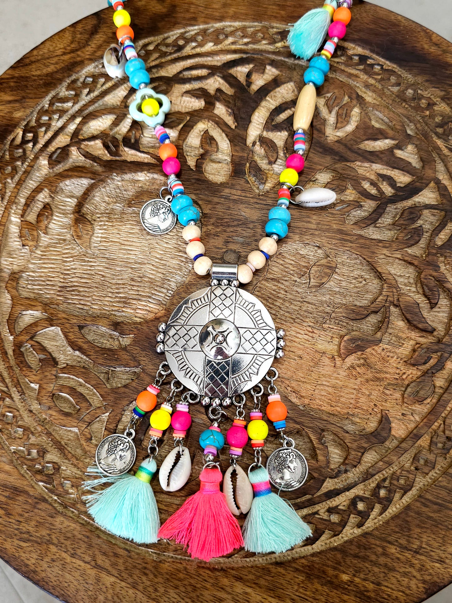 Aztec necklace with colorful beads, charms, and cowrie shell pendant