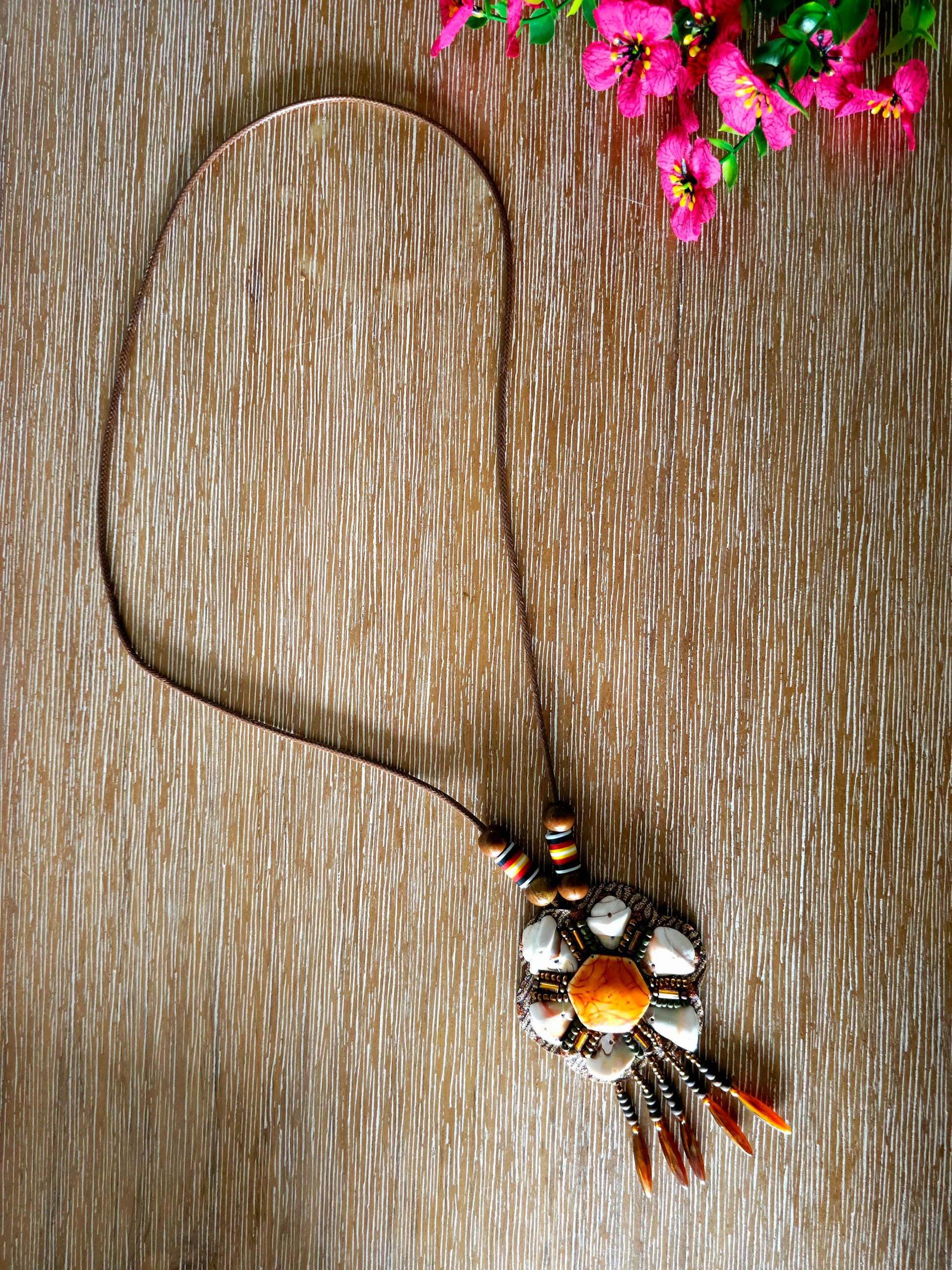 Boho amber pendant necklace with floral design and earthy beads
