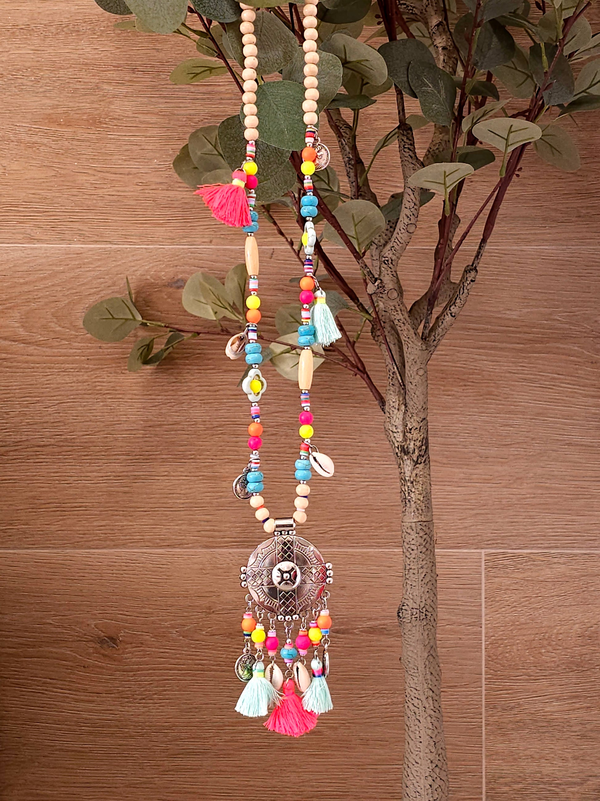 Aztec necklace with colorful beads, charms, and cowrie shell pendant