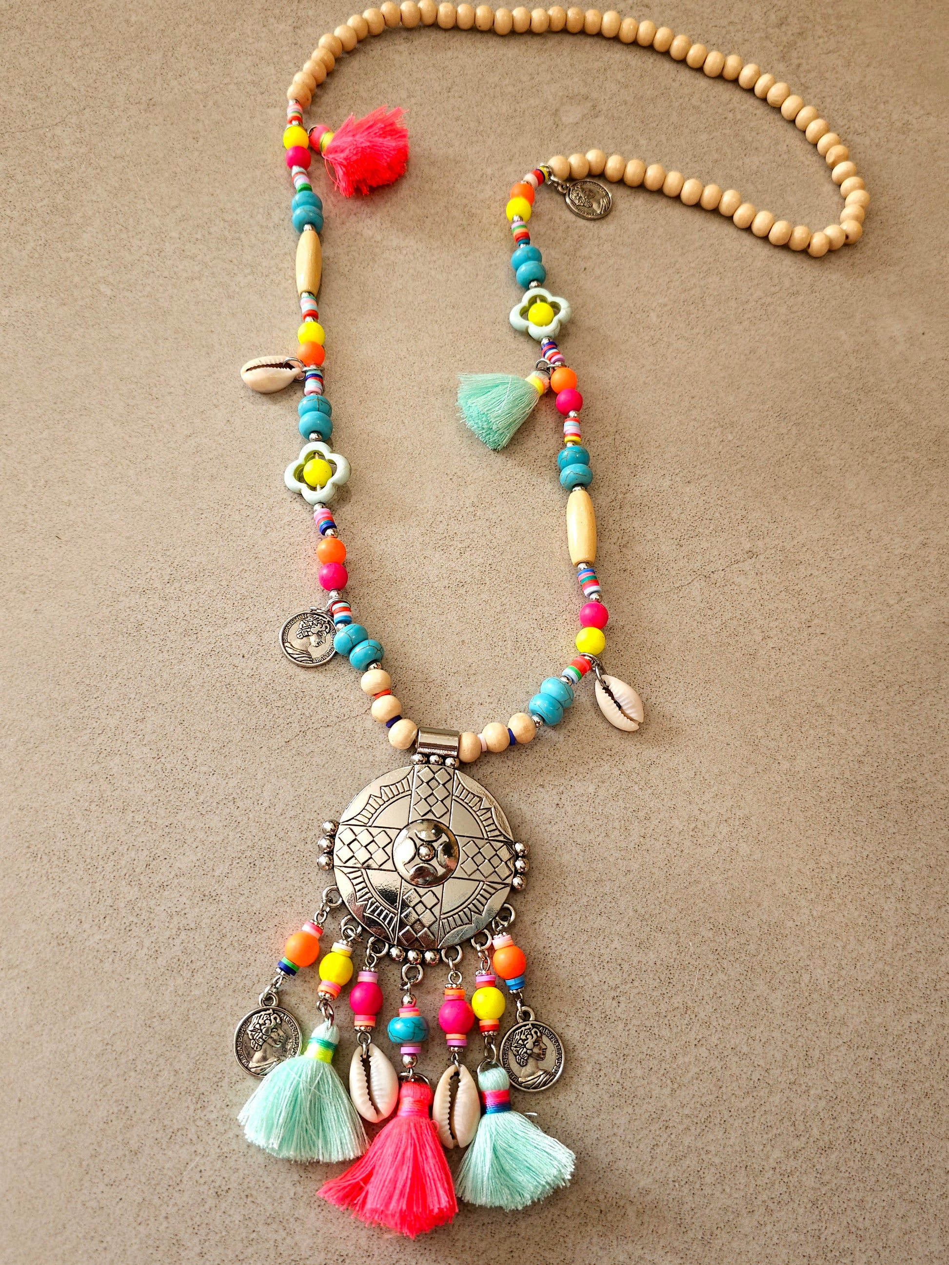 Aztec necklace with colorful beads, charms, and cowrie shell pendant