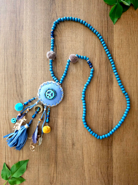 Boho peace necklace with tassels, feathers, and intricate beadwork